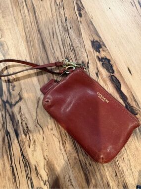 COACH Rust Red Leather Wristlet with Gold Logo